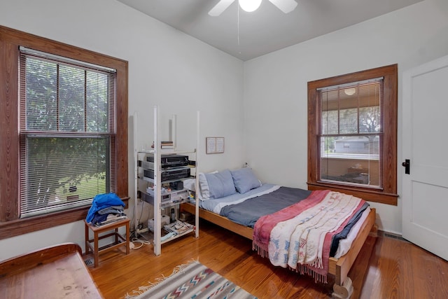 bedroom with hardwood / wood-style floors and ceiling fan