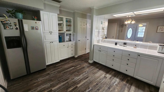 kitchen featuring tile countertops, dark wood-style floors, stainless steel fridge with ice dispenser, and white cabinets