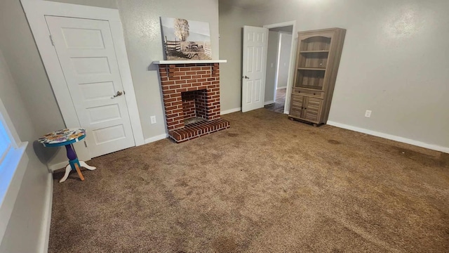 carpeted living room with a fireplace and baseboards