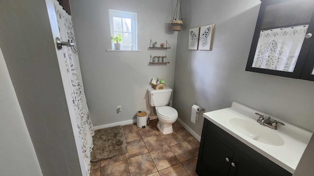 bathroom featuring vanity, a shower with shower curtain, baseboards, tile patterned flooring, and toilet