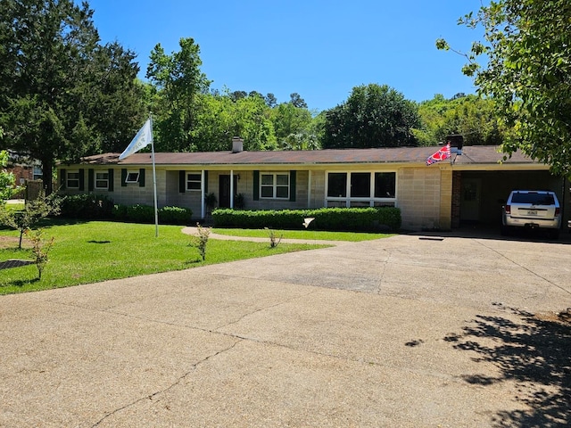 ranch-style house featuring a garage and a front lawn