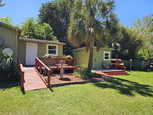 819 Abbiegail Dr, Tallahassee, FL 32303 - back of property featuring an outbuilding, a storage shed, a yard, and a deck