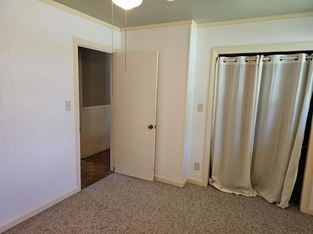 819 Abbiegail Dr, Tallahassee, FL 32303 - unfurnished bedroom featuring light carpet, wooden walls, baseboards, and ornamental molding