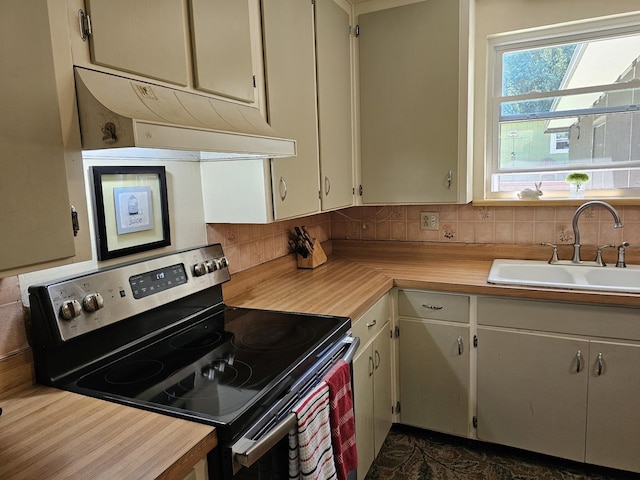819 Abbiegail Dr, Tallahassee, FL 32303 - kitchen featuring stainless steel range with electric stovetop, under cabinet range hood, a sink, light countertops, and decorative backsplash