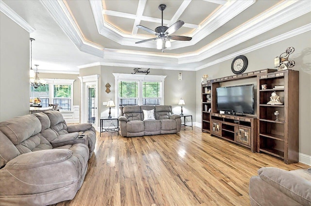 living area with ornamental molding, baseboards, wood finished floors, and ceiling fan with notable chandelier