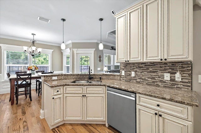 kitchen with a sink, visible vents, cream cabinetry, dishwasher, and a peninsula