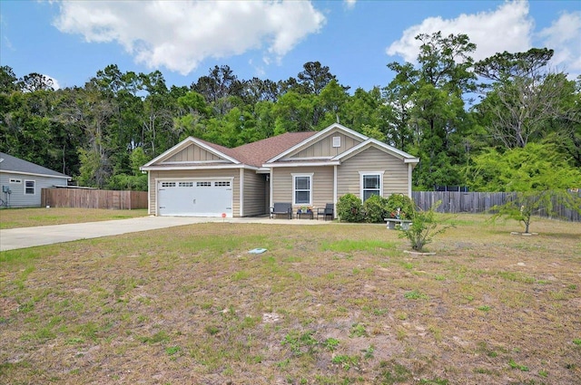 view of front of property with fence, driveway, board and batten siding, and a garage
