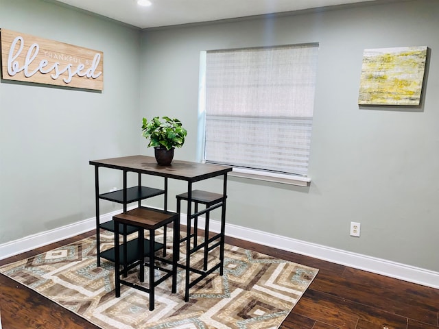 dining area featuring hardwood / wood-style floors and crown molding