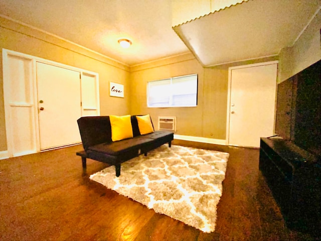 living area featuring hardwood / wood-style floors and crown molding