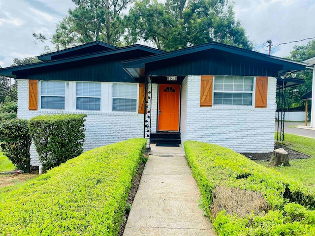 bungalow-style home with a front yard