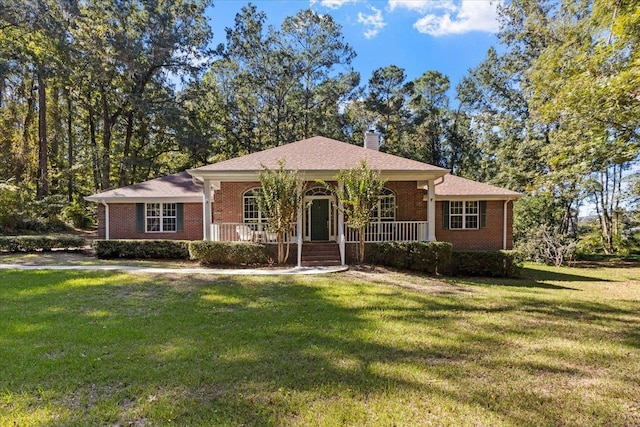 single story home featuring covered porch and a front yard