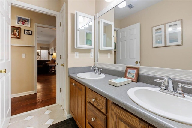 bathroom featuring hardwood / wood-style flooring, vanity, and crown molding