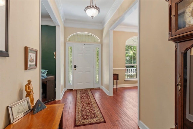 entryway with dark hardwood / wood-style floors and crown molding