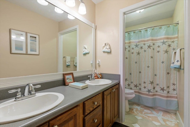 bathroom featuring toilet, vanity, and curtained shower