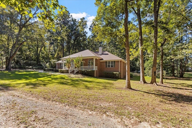 single story home with covered porch and a front lawn