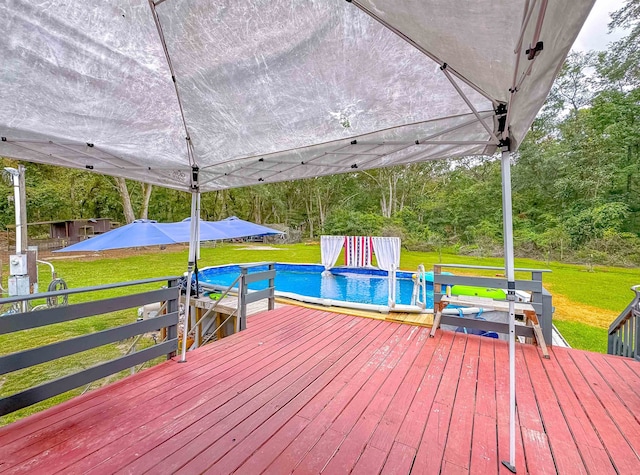 wooden deck featuring a lawn