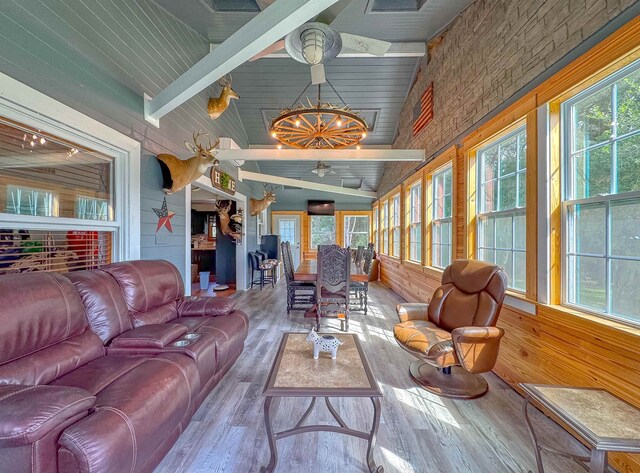 sunroom with a wealth of natural light and lofted ceiling with beams