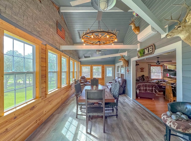 dining space featuring a healthy amount of sunlight and vaulted ceiling with beams