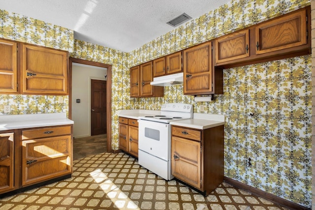 kitchen with a textured ceiling and electric range