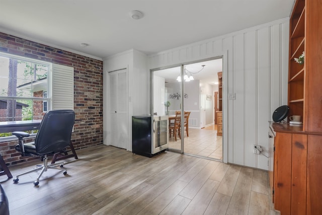 1917 Sharon Rd, Tallahassee, FL 32303 - office with brick wall, light wood-style flooring, a chandelier, and crown molding
