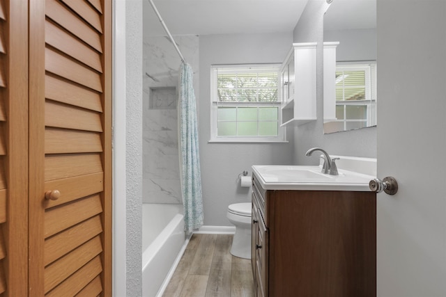 1917 Sharon Rd, Tallahassee, FL 32303 - bathroom featuring vanity, toilet, wood finished floors, shower / bath combo with shower curtain, and baseboards