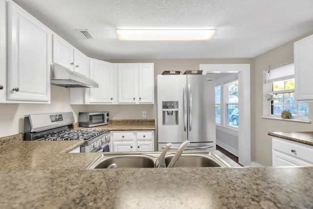 kitchen with white cabinetry, appliances with stainless steel finishes, and sink