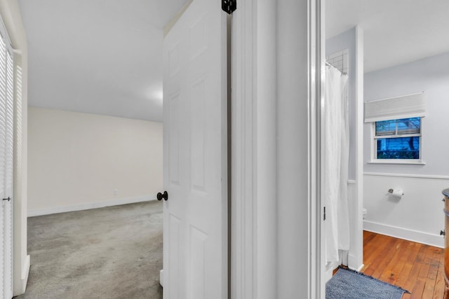 bathroom featuring hardwood / wood-style floors and toilet