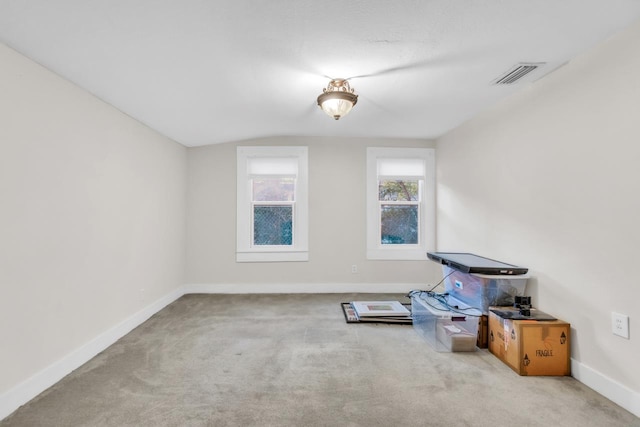 misc room featuring light carpet and lofted ceiling