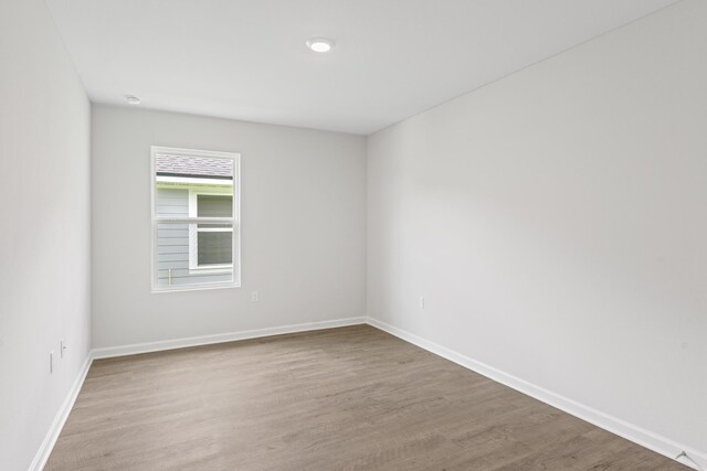 spare room with light hardwood / wood-style flooring