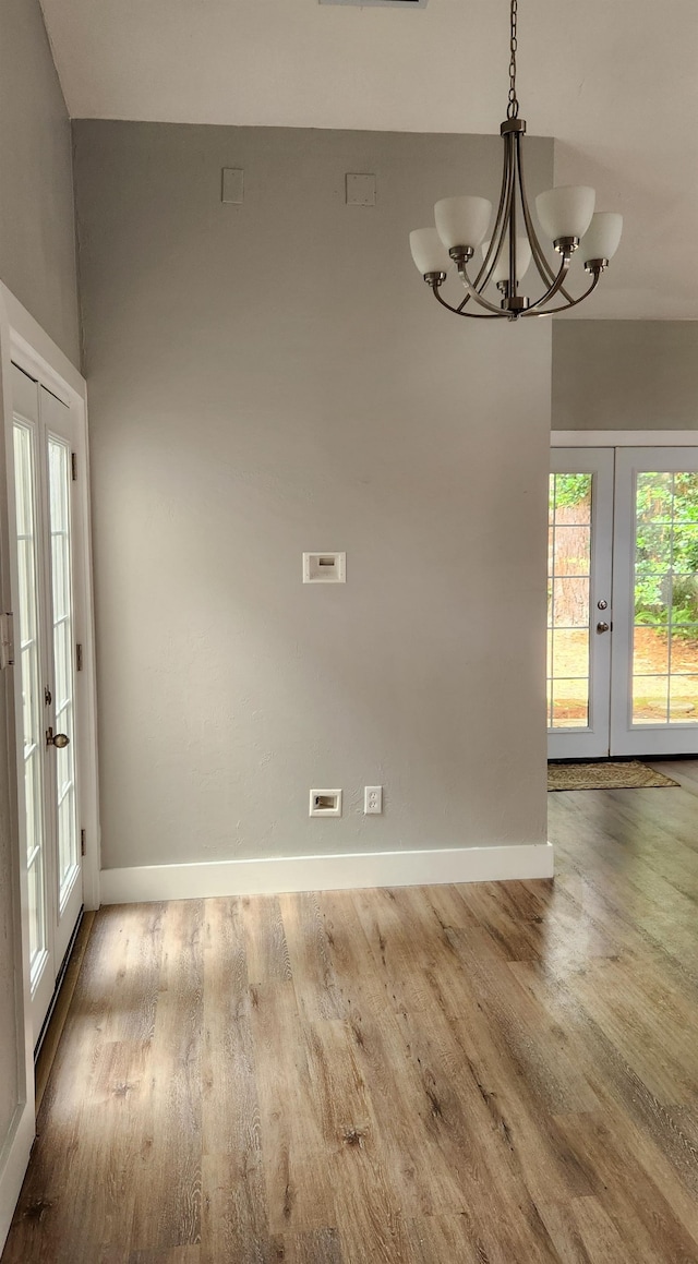 unfurnished dining area featuring french doors and light hardwood / wood-style flooring