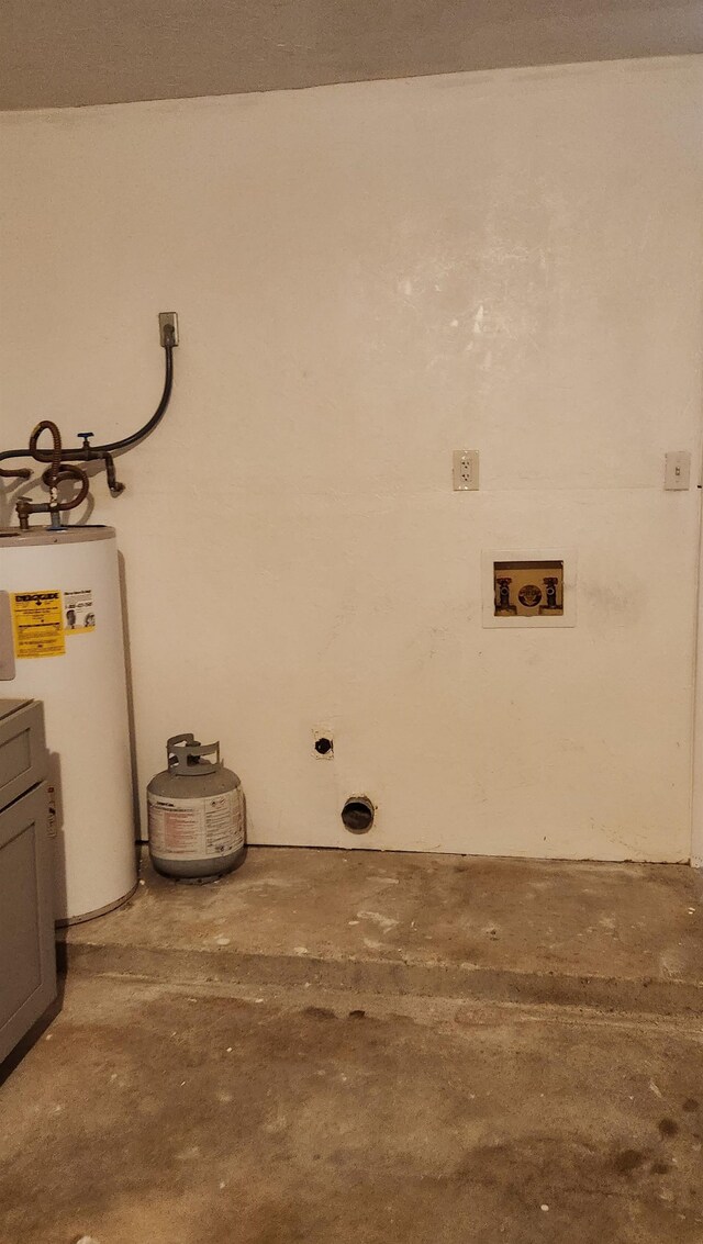 clothes washing area with hookup for an electric dryer, washer hookup, cabinets, and gas water heater