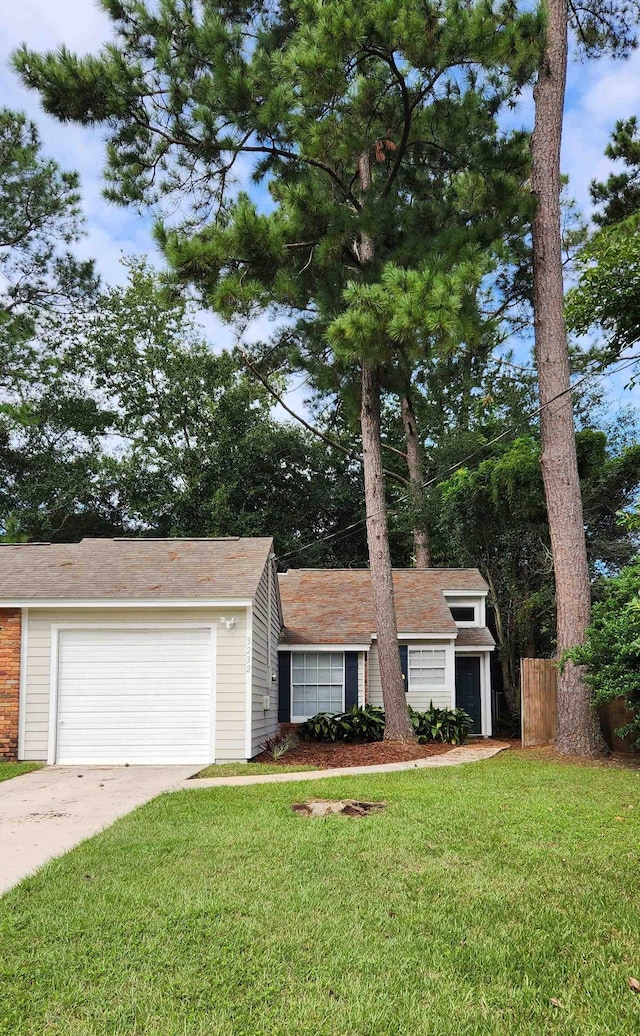 view of front of house with a front yard and a garage