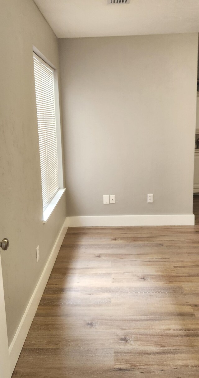 empty room with light hardwood / wood-style flooring