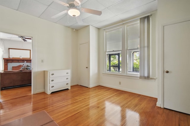 1118 W Green St, Perry, FL 32347 - unfurnished bedroom featuring wood finished floors, a paneled ceiling, ceiling fan, and baseboards