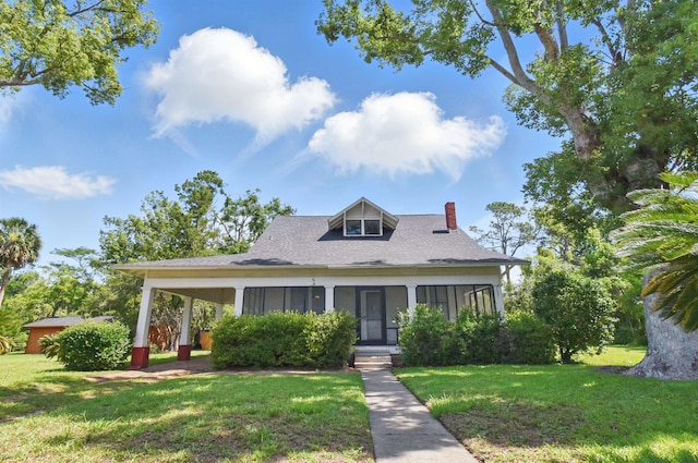 1118 W Green St, Perry, FL 32347 - view of front of house with a chimney, a front yard, and roof with shingles
