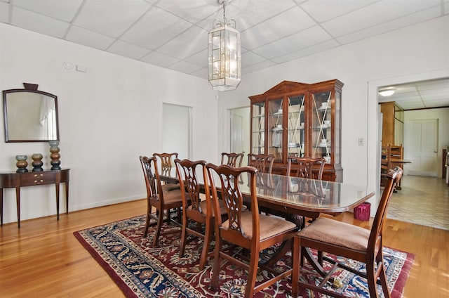 1118 W Green St, Perry, FL 32347 - dining area featuring a paneled ceiling, light wood-style floors, and a chandelier