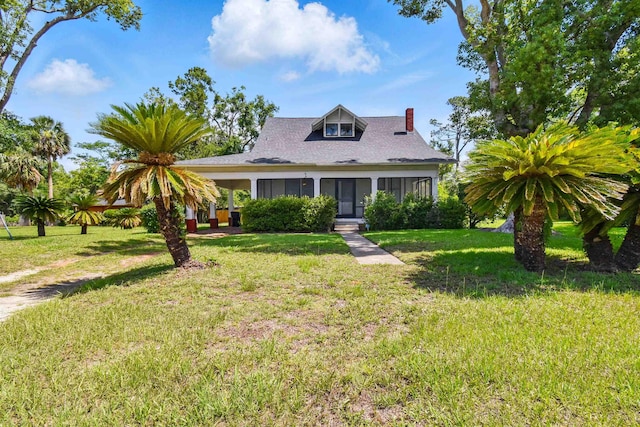 1118 W Green St, Perry, FL 32347 - bungalow-style house featuring a chimney, a front yard, and a shingled roof