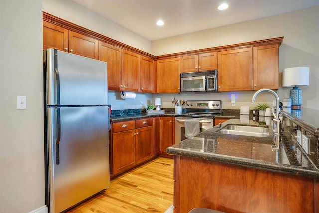 415 Saint Francis St Unit 133, Tallahassee, FL 32301 - kitchen featuring appliances with stainless steel finishes, a sink, brown cabinetry, light wood finished floors, and recessed lighting