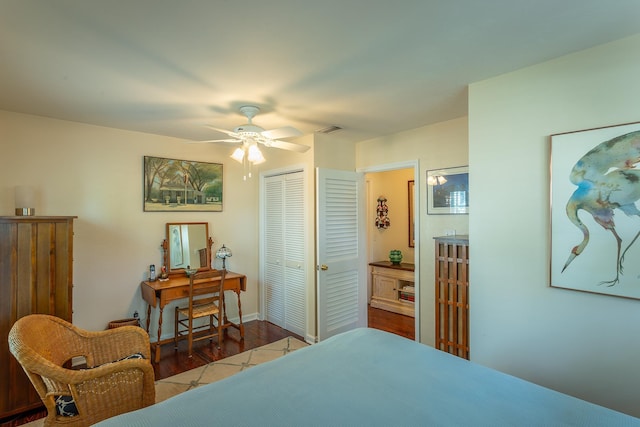 bedroom with wood-type flooring, a closet, and ceiling fan