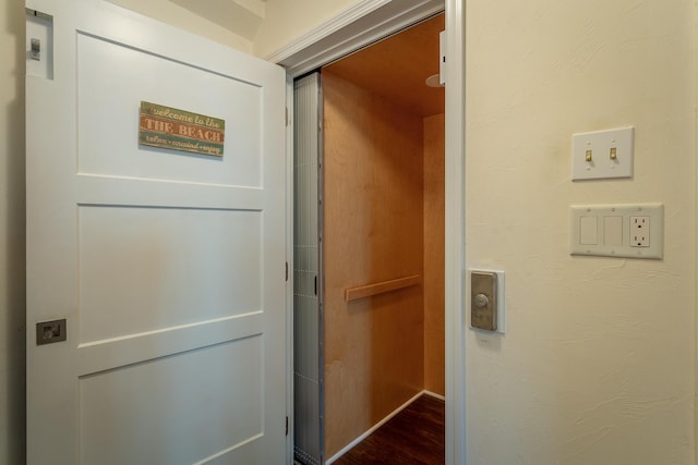 corridor with dark hardwood / wood-style flooring