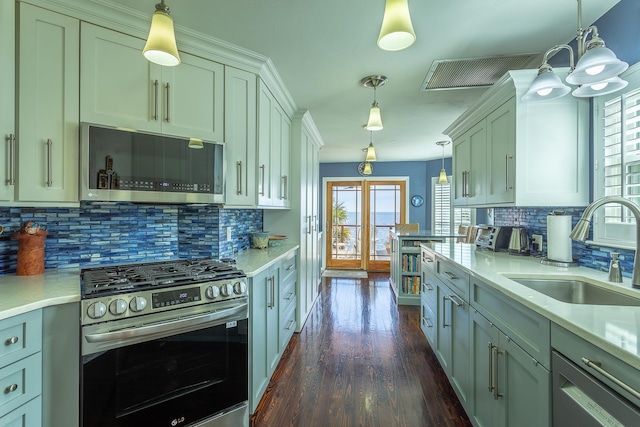 kitchen featuring sink, decorative light fixtures, and stainless steel appliances