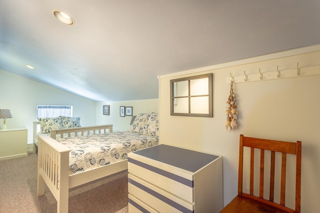 bedroom featuring dark carpet and vaulted ceiling