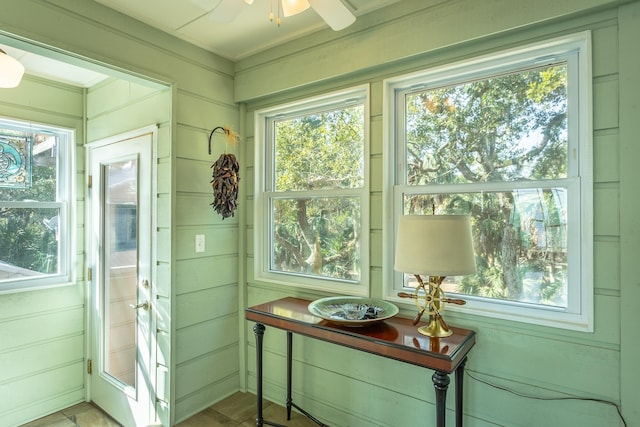 sunroom / solarium featuring ceiling fan