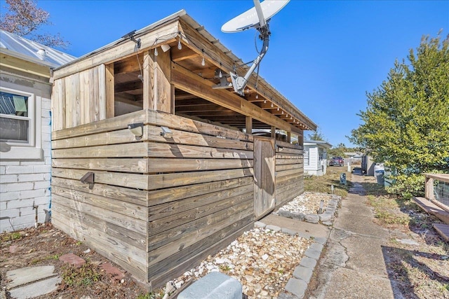 view of property exterior with an outdoor structure