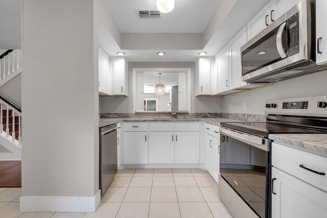 1806 Atlantis Pl, Tallahassee, FL 32303 - kitchen with visible vents, appliances with stainless steel finishes, white cabinetry, and a sink