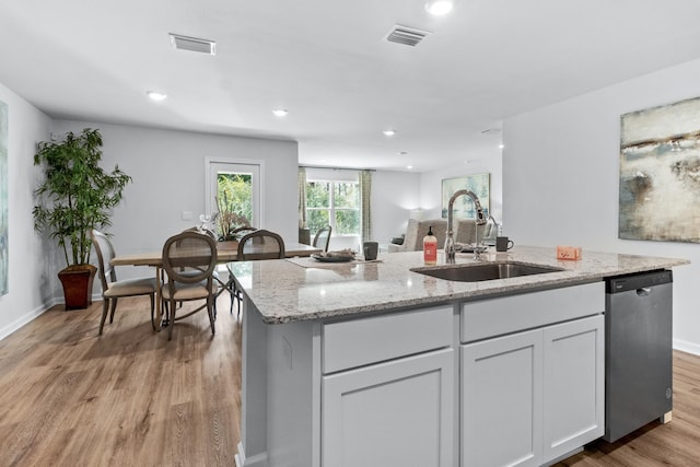 223 Milestone Trl, Crawfordville, FL 32327 - kitchen with dishwasher, light wood-style flooring, light stone counters, recessed lighting, and white cabinets