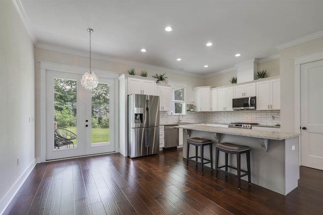 834 Piney Village Loop, Tallahassee, FL 32311 - kitchen with stainless steel appliances, decorative backsplash, a sink, a breakfast bar area, and recessed lighting