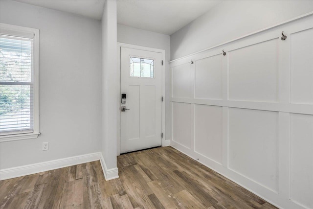 entryway with wood finished floors and baseboards