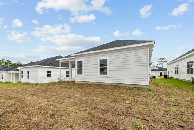5698 Pinebarren Rd, Tallahassee, FL 32303 - back of house featuring a lawn and central AC unit