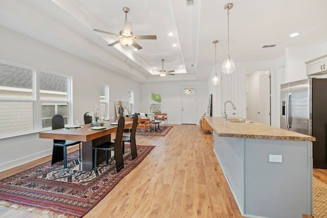5698 Pinebarren Rd, Tallahassee, FL 32303 - kitchen with a sink, stainless steel fridge, light wood-type flooring, a tray ceiling, and recessed lighting